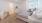 a large room with a bed and a chair