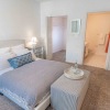 a bedroom with a bed and a chair