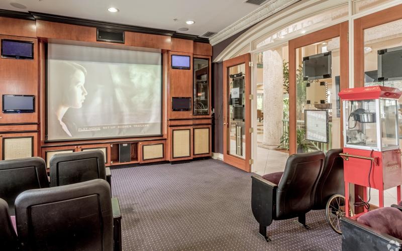 a room with chairs and a screen
