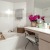 a bathroom with a tub sink and a mirror